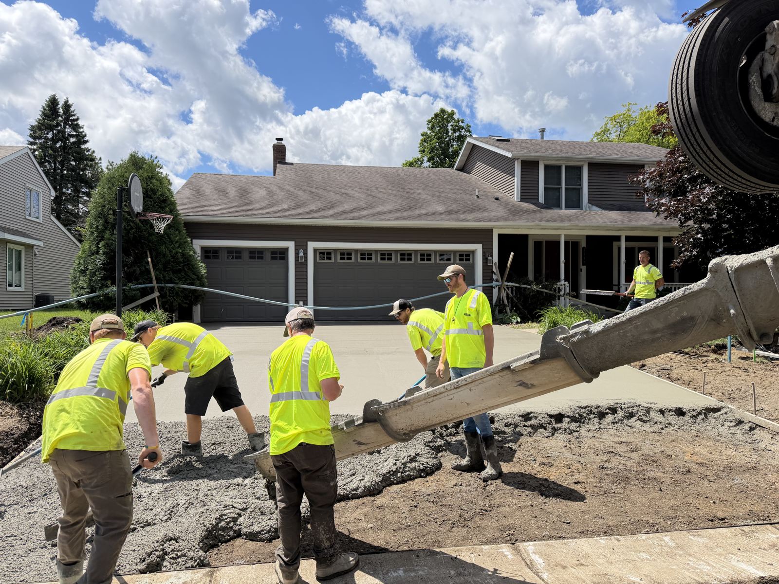Crew placing a residential concrete driveway from the chute